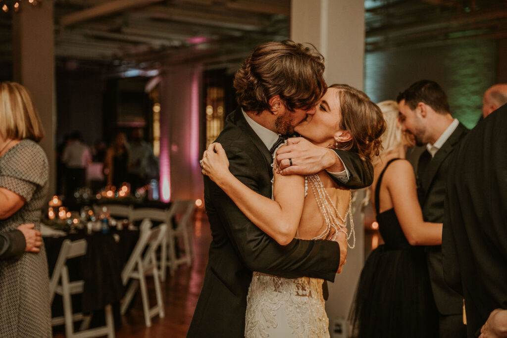 The bride and groom kissing on the dance floor of the BLDG17 Cleveland wedding venue