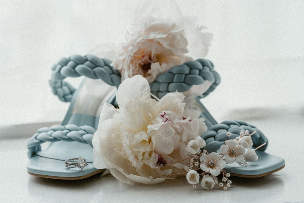 Coastal chic wedding flowers, shoes and jewelry in soft blue and white hues